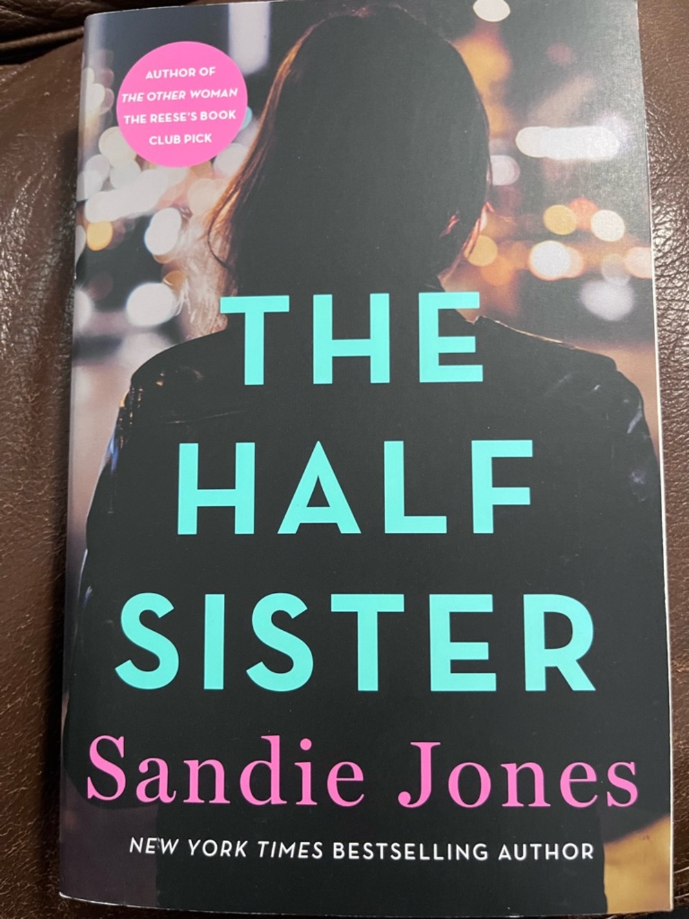 The Half Sister by Sandie Jones - Black Cover with Teal & Pink Text